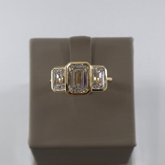 LAB GROWN 14KY 2.08CT EMERALD CUT CENTER DIAMOND / 2.05CTW EMERALD ON EACH SIDE BEZEL SET 3 STONE RING LABDRCD802